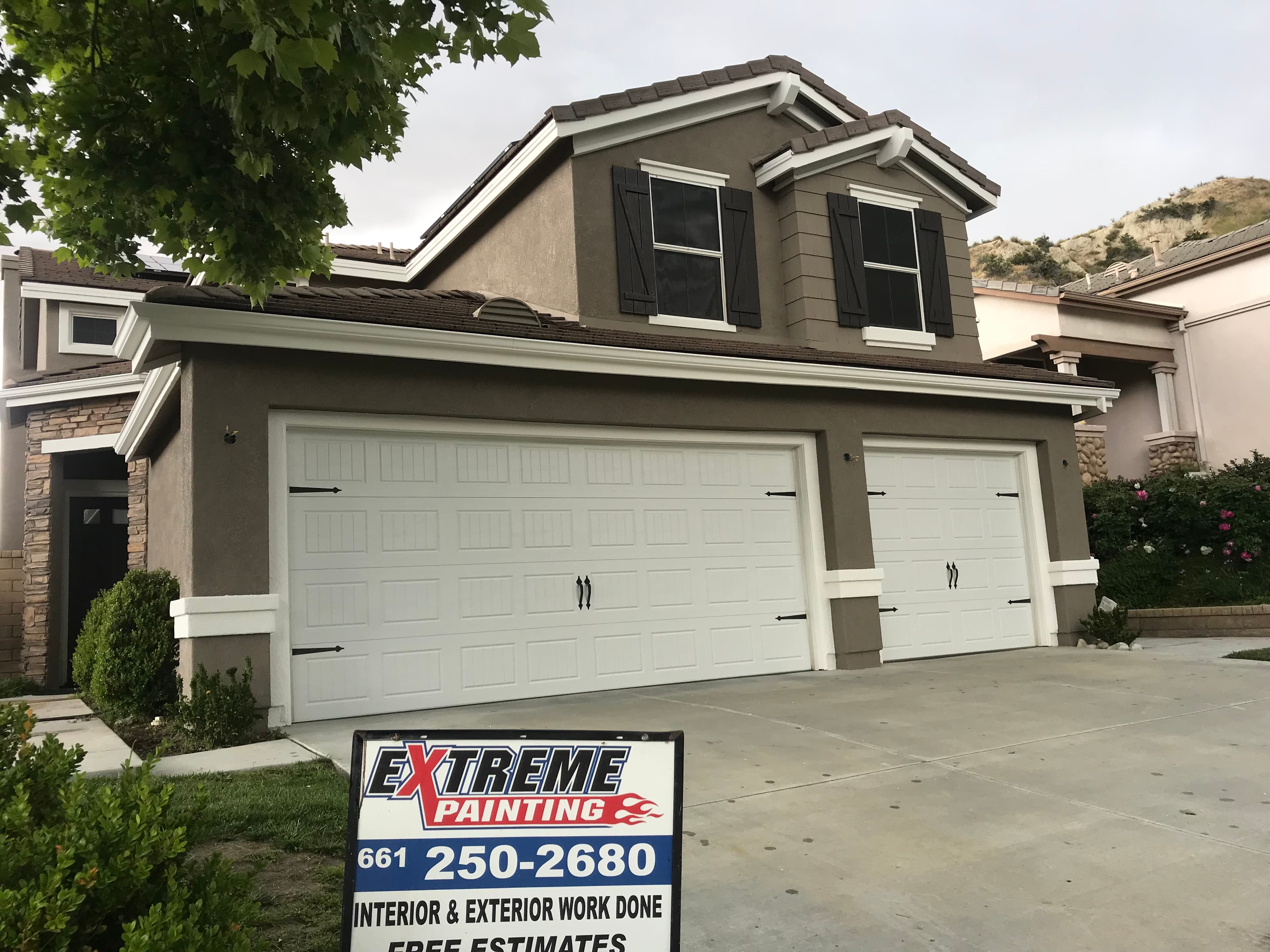 Before image by extreme painting for Residential exterior with two garage, repainted.